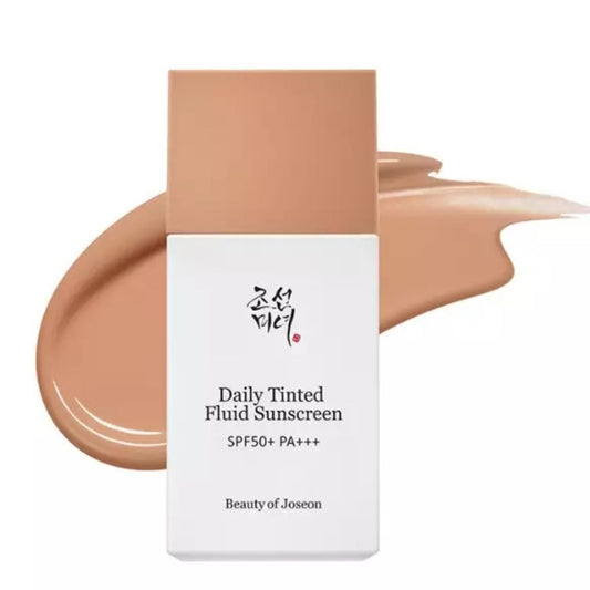 Beauty of Joseon Daily Tinted Fluid Sunscreen SPF50+ PA+++ in a white rectangular bottle with a peach-colored cap, shown in front of a peachy-beige liquid smear on a white background.