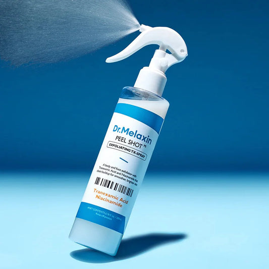 A bottle of Dr. Melaxin Peel Shot exfoliating treatment spray, shown with a mist spray coming out of the trigger nozzle against a blue gradient background.