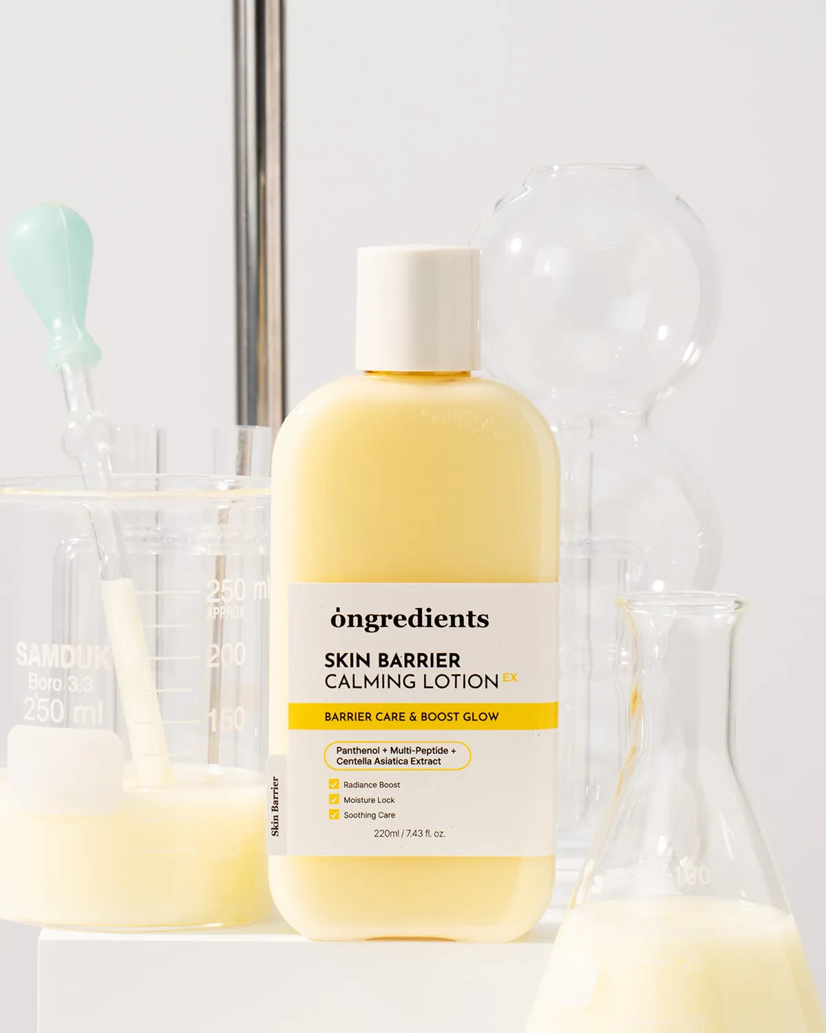 Bottle of 'ongredients Skin Barrier Calming Lotion' with a white label on a blurred background.