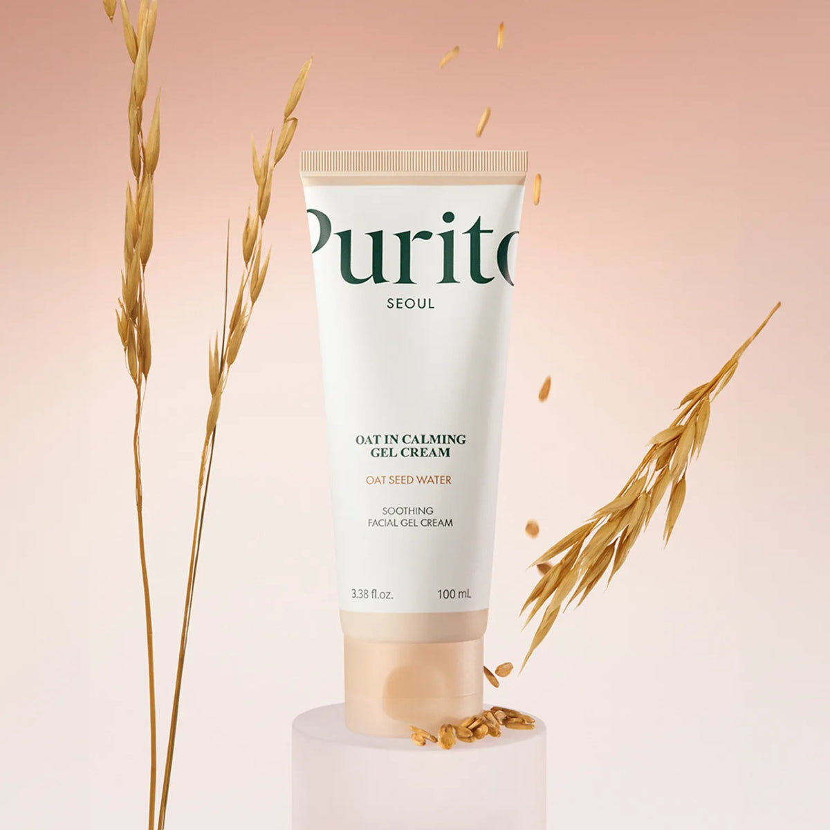 Purito oat cream tube with dried oats on a pink background