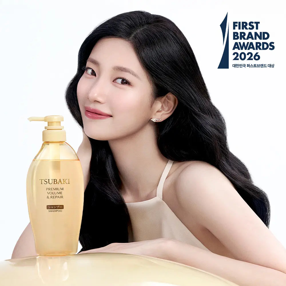 Woman with long black hair holding a bottle of Tsubaki shampoo, with 'First Brand Awards 2026' logo in the corner.