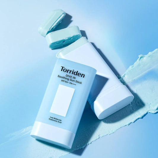 Torriden sunscreen stick on a light blue background