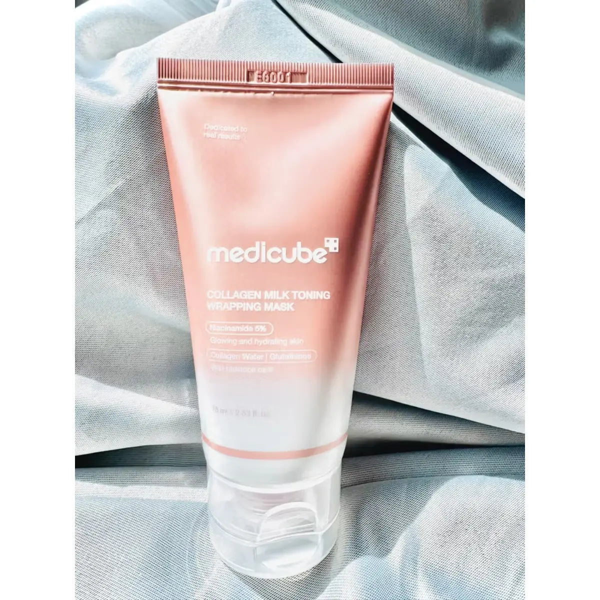 Medicube Collagen Milk Toning Wrapping Mask 75ml tube on fabric in Pakistan