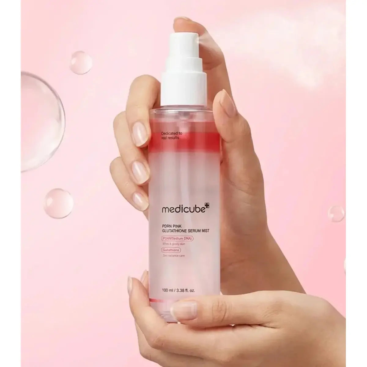 Medicube PDRN Pink Glutathione Serum Mist 100ml held in hands in Pakistan
